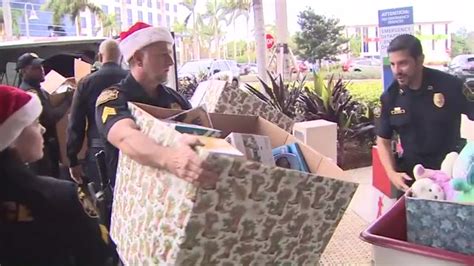 Miramar Police officers stop by Joe DiMaggio Children’s Hospital to deliver gifts in 15-year Christmas tradition